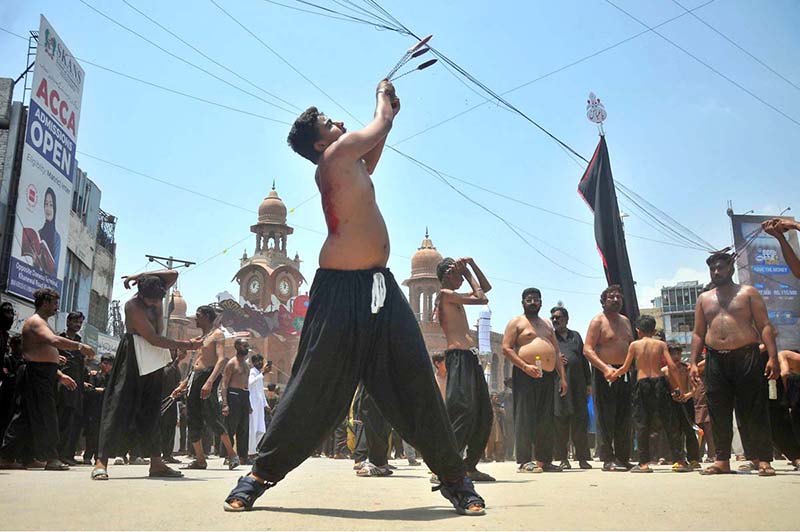 Mourners oozing themselves with knives and chains during the main Ashura procession on the 10th of Muharram-ul-Haram at Ghanta Ghar Chowk. Muharram-ul-Haram is the first month of the Islamic calendar, observed as a month of mourning in remembrance of the martyrdom (Shahadat) of Hazrat Imam Hussain (R.A.), the grandson of the Holy Prophet Muhammad (PBUH)