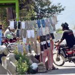 A roadside vendor displays socks and hand gloves for sale at roadside, as informal street vending continues to serve as a source of livelihood for many in the Federal Capital