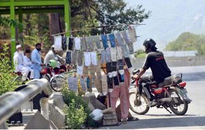 A roadside vendor displays socks and hand gloves for sale at roadside, as informal street vending continues to serve as a source of livelihood for many in the Federal Capital