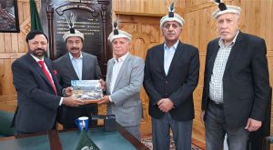 Chief Election Commissioner Gilgit-Baltistan Raja Shahbaz Khan receives a commemorative publication from members of the Lahore Educationists Association during a meeting at the Election Commission Office.