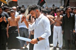 Mourners oozing themselves with knives and chains during the main Ashura procession on the 10th of Muharram-ul-Haram at Ghanta Ghar Chowk. Muharram-ul-Haram is the first month of the Islamic calendar, observed as a month of mourning in remembrance of the martyrdom (Shahadat) of Hazrat Imam Hussain (R.A.), the grandson of the Holy Prophet Muhammad (PBUH)