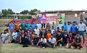Divisional Sports Officer and District Sports Officer Saima Manzoor pose for group photo with position holders during the Inter-District Athletics Championship organized by the Divisional Sports Department at the Sports Stadium.