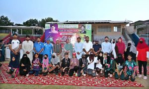 Divisional Sports Officer and District Sports Officer Saima Manzoor pose for group photo with position holders during the Inter-District Athletics Championship organized by the Divisional Sports Department at the Sports Stadium.