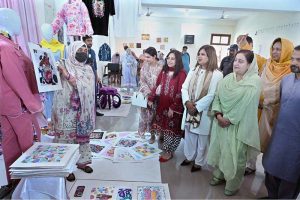Secretary Women Development Punjab Suman Roy and Vice Chancellor Government College Women University Sialkot (GCWUS) Dr. Shazia Bashir viewing artworks at a Fine Arts exhibition featuring creations by final-year students.