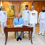 Prime Minister Muhammad Shehbaz Sharif writing his remarks in the visitors' book at Pakistan Naval Academy, PNS Rahbar