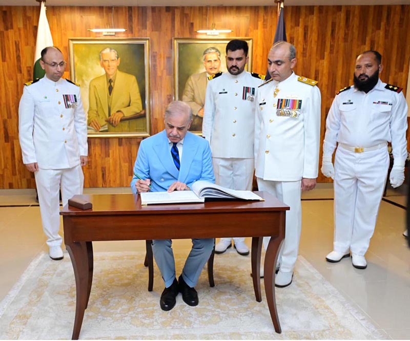 Prime Minister Muhammad Shehbaz Sharif writing his remarks in the visitors' book at Pakistan Naval Academy, PNS Rahbar