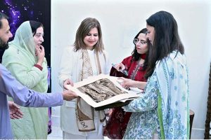 Secretary Women Development Punjab Suman Roy and Vice Chancellor Government College Women University Sialkot (GCWUS) Dr. Shazia Bashir viewing artworks at a Fine Arts exhibition featuring creations by final-year students.