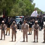 Security officials standing high alert in front of mourners attending a procession on 9th of Murramul Harram at Latifabad. Muharramul Haram is known as the first month of the Islamic calendar and the mourning month in remembrance of the martyrdom (Shahadat) of Hazrat Imam Hussain (RA), the grandson of the Holy Prophet Mohammad (PBUH)
