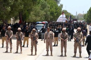 Security officials standing high alert in front of mourners attending a procession on 9th of Murramul Harram at Latifabad. Muharramul Haram is known as the first month of the Islamic calendar and the mourning month in remembrance of the martyrdom (Shahadat) of Hazrat Imam Hussain (RA), the grandson of the Holy Prophet Mohammad (PBUH)