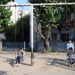 Children enjoy swings at a neighborhood park, as they make the most of their summer holidays, finding simple outdoor fun despite the scorching heat gripping the capital