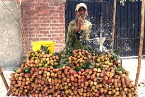 A street vendor sprinkles water on lychees at a roadside stall at Anarkali Chowk to keep them cool and fresh as the summer fruit season gets underway.