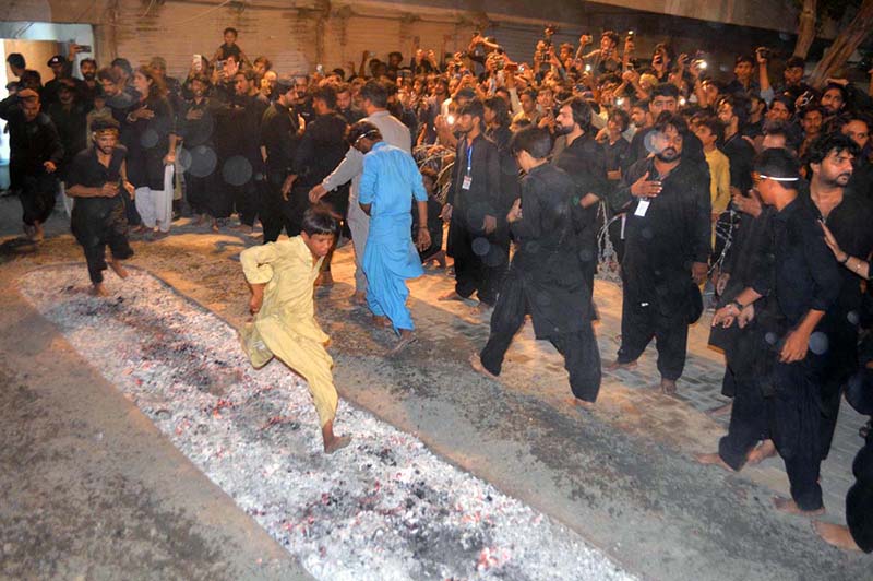 Mourners walking on burning coals during a procession on 9th of Murramul Harram at Tando Jahania. Muharramul Haram is known as the first month of the Islamic calendar and the mourning month in remembrance of the martyrdom (Shahadat) of Hazrat Imam Hussain (RA), the grandson of the Holy Prophet Mohammad (PBUH)