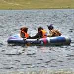 Tourists enjoy boating in Shandur Lake, a breathtaking alpine glacial lake at 3,700 meters on the Shandur Plateau, located between Chitral and Ghizer