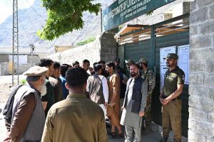 Voters queue outside a polling station, as security personnel stand guard during the Gilgit-Baltistan General Elections 2026.