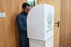 Voters queue outside a polling station, as security personnel stand guard during the Gilgit-Baltistan General Elections 2026.