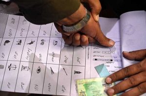 Voters queue outside a polling station, as security personnel stand guard during the Gilgit-Baltistan General Elections 2026.