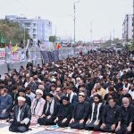 Mourners offering Zuhr prayers on M.A. Jinnah Road during the 9th Muharram-ul-Haram procession
