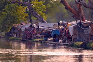 A view of makeshift shelters established along the Nau Bahar Canal, where informal settlements have transformed the canal's riverside environment