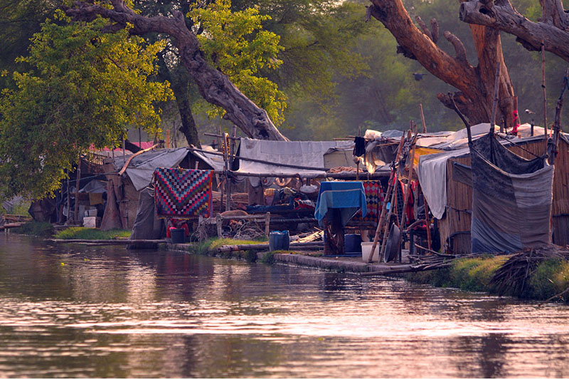 A view of makeshift shelters established along the Nau Bahar Canal, where informal settlements have transformed the canal's riverside environment