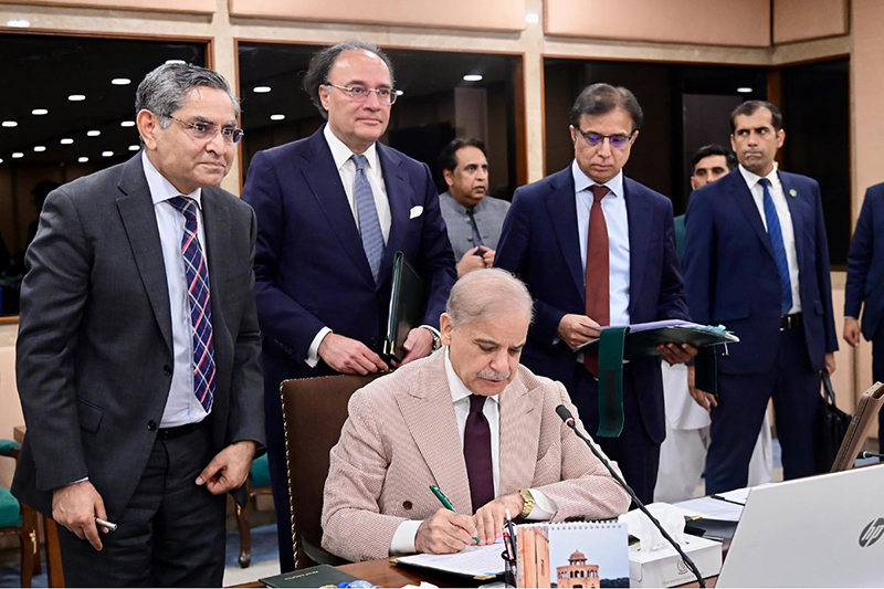 Prime Minister Muhammad Shehbaz Sharif signing Annual Budget 2026-27 documents after its approval by the Federal Cabinet meeting at Parliament House