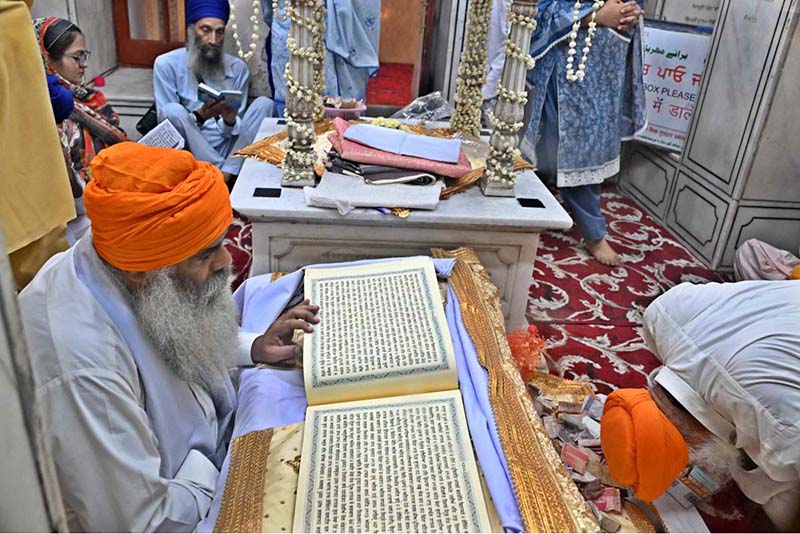 Sikh pilgrims perform rituals during a ceremony marking the Martyrdom Day of Guru Arjan Dev Ji at Gurdwara Dera Sahib. Hundreds of pilgrims are attending the 420th anniversary of the fifth Sikh Guru’s martyrdom