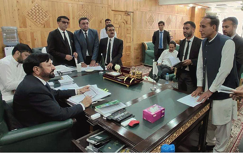 Chief Election Commissioner Gilgit-Baltistan Raja Shahbaz Khan hears appeals filed by candidates regarding election matters at his office, with officials and legal representatives also present during the proceedings