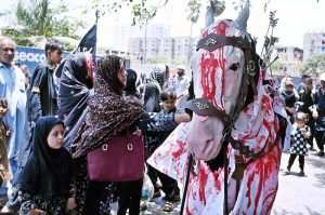 Mourners touches a Zuljinah during the Ashura procession on 10th of the Muharram-ul-Harram. Muharram-ul-Harram is the first month of the Islamic calendar known as the mourning month in remembrance of the martyrdom (Shahadat) of Hazrat Imam Hussain (RA), the grandson of the Holy Prophet Muhammad (PBUH)