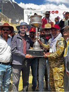 Secretary Tourism Gilgit-Baltistan, Sardar Asad Haroon, along with other officials present the Shandur Polo Festival 2026 trophy to the winning Gilgit-Baltistan team captain at the historic Shandur Polo Ground, following their thrilling 6-5 victory over Chitral in the final