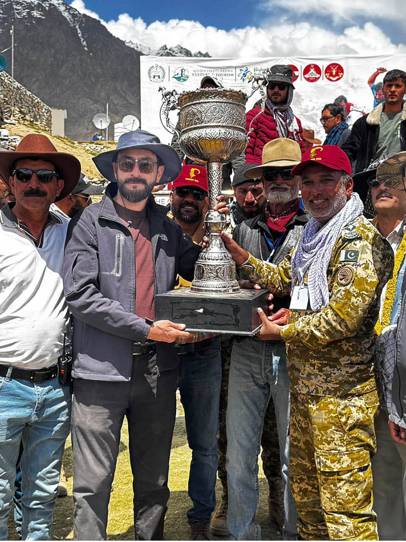 Secretary Tourism Gilgit-Baltistan, Sardar Asad Haroon, along with other officials present the Shandur Polo Festival 2026 trophy to the winning Gilgit-Baltistan team captain at the historic Shandur Polo Ground, following their thrilling 6-5 victory over Chitral in the final