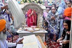 Sikh pilgrims perform rituals during a ceremony marking the Martyrdom Day of Guru Arjan Dev Ji at Gurdwara Dera Sahib. Hundreds of pilgrims are attending the 420th anniversary of the fifth Sikh Guru’s martyrdom