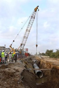 Engineers and workers are actively engaged in development work on the Red Line BRT project, with heavy machinery in operation along University Road in the provincial capital