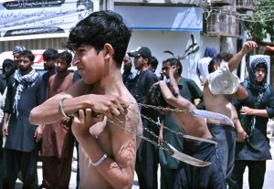 Mourners self-flagellation with knives and chains during the Ashura procession on 10th of the Muharram-ul-Harram at Tibet Center. Muharram-ul-Harram is the first month of the Islamic calendar known as the mourning month in remembrance of the martyrdom (Shahadat) of Hazrat Imam Hussain (RA), the grandson of the Holy Prophet Muhammad (PBUH)