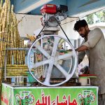 A vendor is busy making sugarcane juice at Sheikh Zayed Children Hospital Road