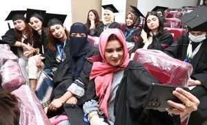 Newly graduated doctors take selfies during the second convocation of Sargodha Medical College