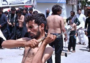 Mourners self-flagellation with knives and chains during the Ashura procession on 10th of the Muharram-ul-Harram at Tibet Center. Muharram-ul-Harram is the first month of the Islamic calendar known as the mourning month in remembrance of the martyrdom (Shahadat) of Hazrat Imam Hussain (RA), the grandson of the Holy Prophet Muhammad (PBUH)