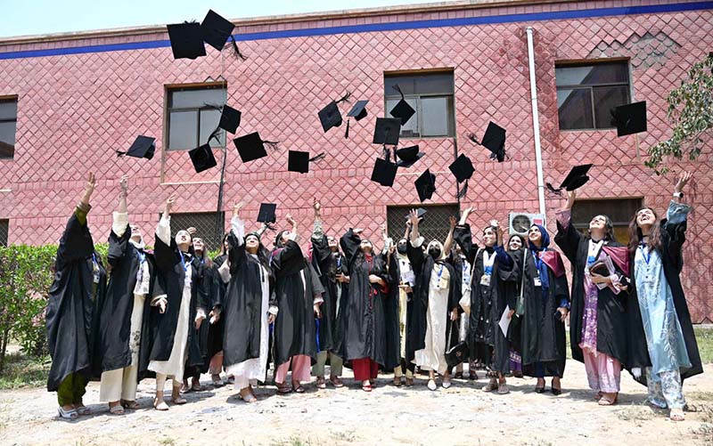 Newly graduated doctors throw their caps in the air in a traditional celebration during the second convocation of Sargodha Medical College