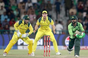 Pakistani players Shadab Khan and Abdul Samad celebrate and shake hands with the Australian players after winning the third One-day International (ODI) cricket match between Pakistan and Australia at Gaddafi Stadium.