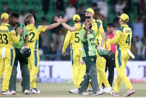 Pakistani players Shadab Khan and Abdul Samad celebrate and shake hands with the Australian players after winning the third One-day International (ODI) cricket match between Pakistan and Australia at Gaddafi Stadium.