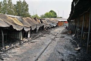 Vendors gather their salvaged goods amid the aftermath of a devastating fire that swept through the weekly H-9 Bazaar near Peshawar Mor in the Federal Capital, leaving numerous shops damaged and traders counting their losses.