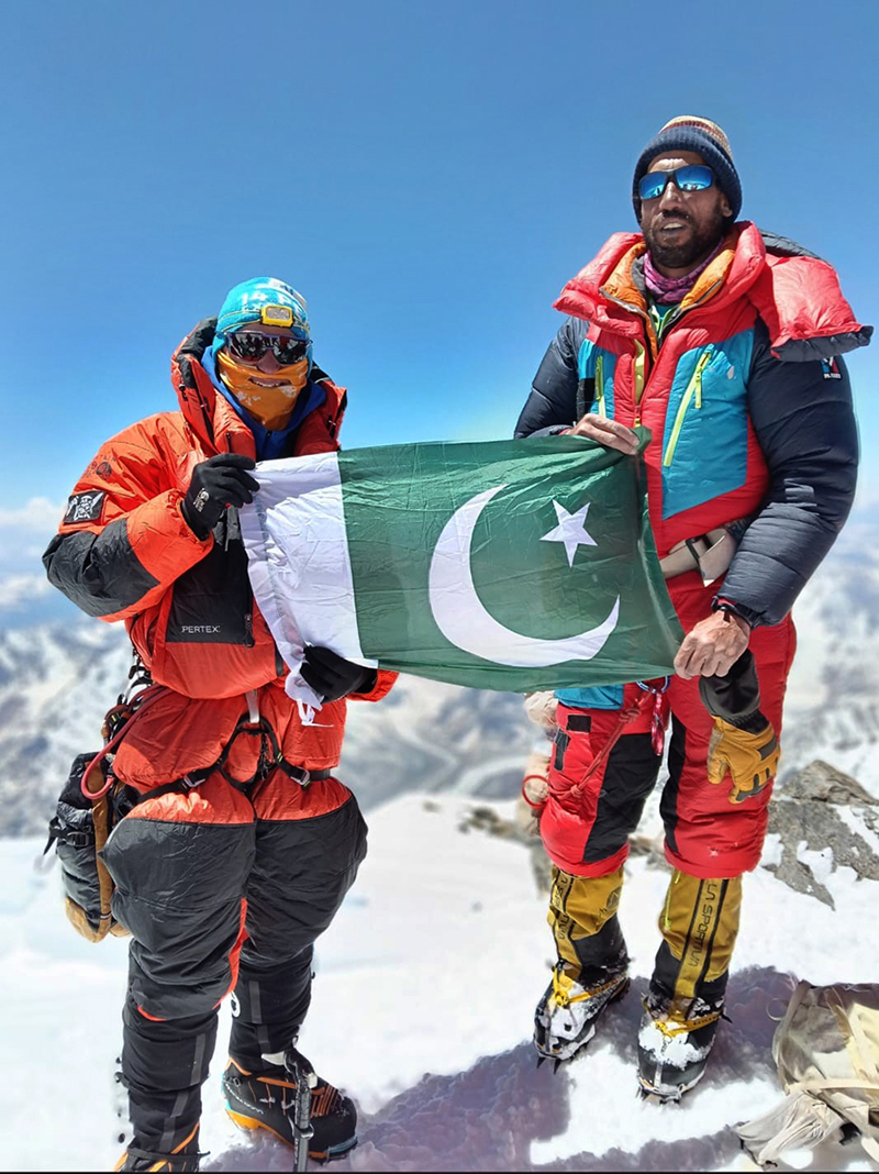 Abbas Ali, 37, from Arandu, Pakistan and renowned alpinist, expedition leader, and mountain guide Benjamin Lieber from Alaska poses with the national flag atop Nanga Parbat (8,125 metres) after reaching the summit on June 30. The expedition team returned to Skardu following the successful ascent. Abbas Ali is among the four Pakistani climbers—including Mehboob Ali Arandu, Muhammad Ali and Ilyas from Hushe—to summit the mountain this year