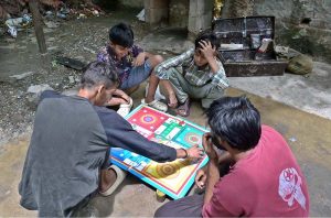 Youngsters are playing Ludo game to spend their time at G-7 in the Federal Capital