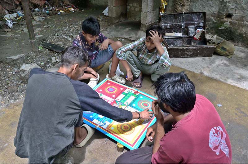 Youngsters are playing Ludo game to spend their time at G-7 in the Federal Capital