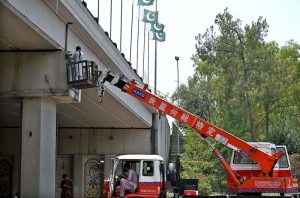 A worker busy installing CCTV camera for safety purpose on bridge near Zero Point.