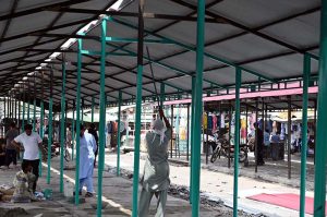 Workers begin reconstruction and rebuilding of shops at H-9 weekly Bazaar, as steel framework structures are erected on the charred remains of the market that was recently gutted in a devastating fire