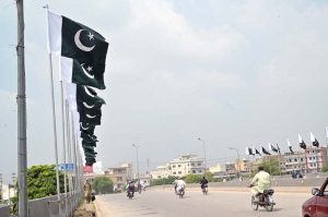 A view of national flags are displayed on bridge at Islamabad Expressway in connection with the upcoming Independence Day celebrations