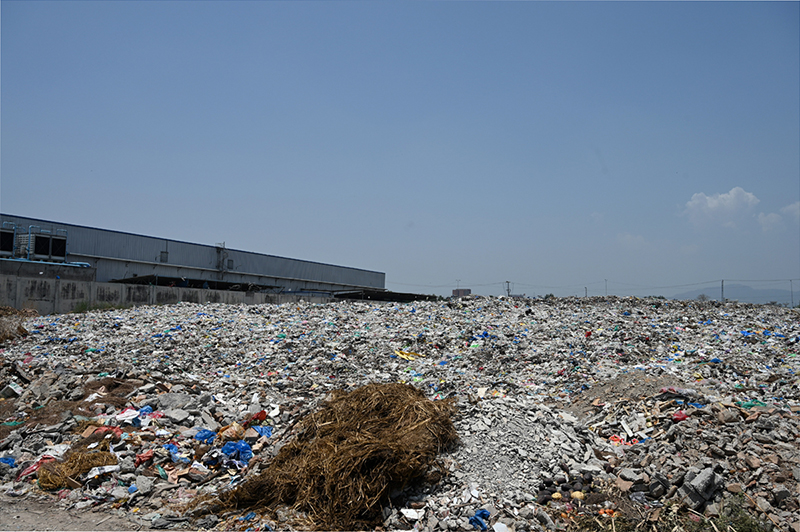 A large heap of garbage and waste lies unattended near a vegetable market, highlighting the poor sanitation and waste management situation that demands urgent attention from the concerned authorities