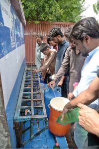 People filling their pots with clean drinking water from filtration plant at Dhoke Kala Khan