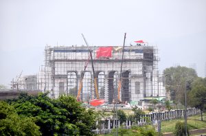 A construction project Marka Haq, underway with heavy machinery and laborers at work.