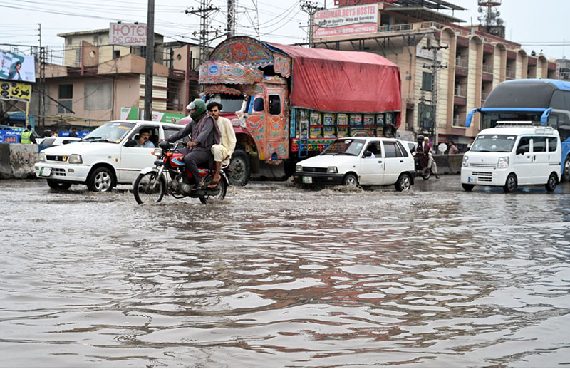 Vehicles passing through rainwater accumulated at IJP Road during rain in the Federal Capital