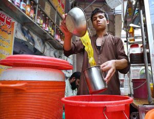 Vendor preparing and selling traditional Gond Katira & dry fruit drink for customers at Namak Mandi area.